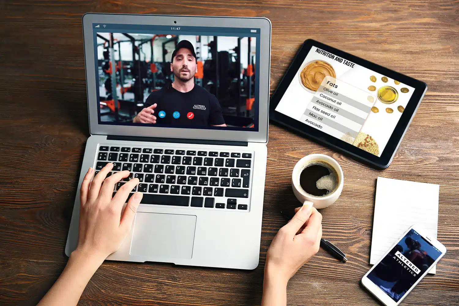 woman talking to Jared during an online personal training virtual meeting with the training app on her phone and food list on her ipad