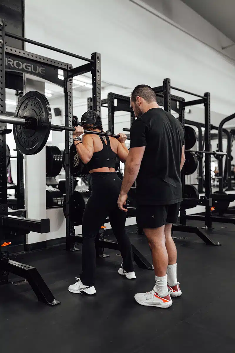 Jared watching proper form during personal training session